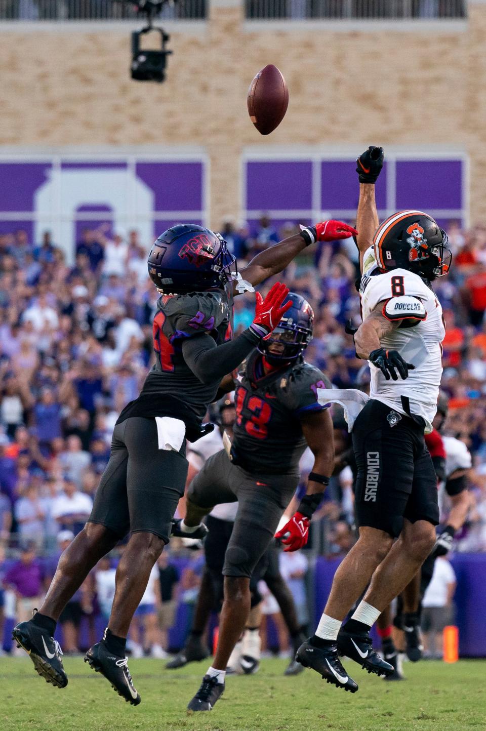Oklahoma State wide receiver Braydon Johnson (8) misses a pass intended for him as TCU cornerback Josh Newton (24) defends during the second overtime period of an NCAA college football game in Fort Worth, Texas, Saturday, Oct. 15, 2022. (AP Photo/Sam Hodde)