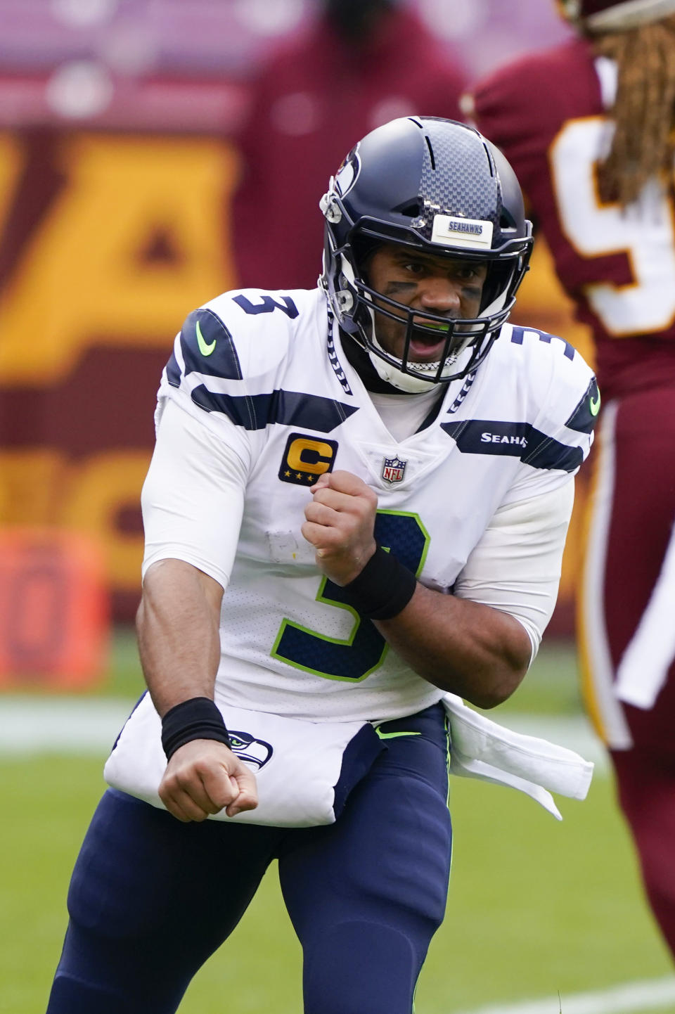 Seattle Seahawks quarterback Russell Wilson (3) celebrating his touchdown pass to tight end Jacob Hollister (86) during the first half of an NFL football game against the Washington Football Team, Sunday, Dec. 20, 2020, in Landover, Md. (AP Photo/Susan Walsh)