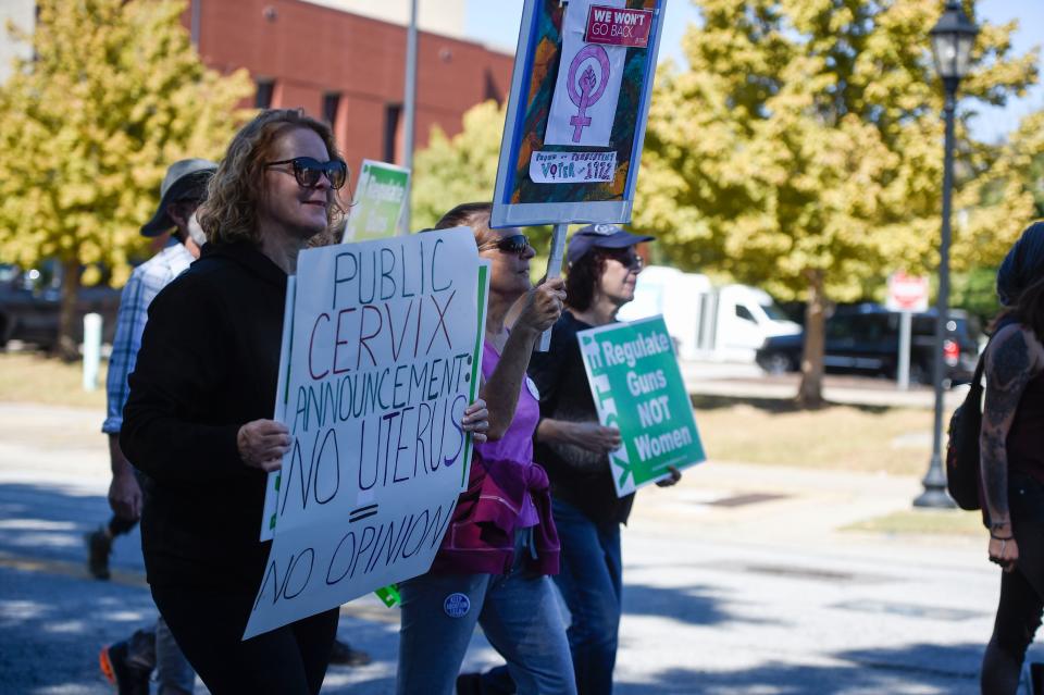 People march down Telfair Street at the Roe, Roe, Roe the Vote rally on Saturday, Oct. 22, 2022. About 60 people came out to march to the Augusta-Richmond County Municipal Building, where some went in to vote. 