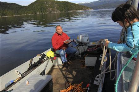 Trevor Amos watches his daughter Arlene while eating left-over spaghetti on his small fishing boat on the Douglas Channel in northern British Columbia near to where Enbridge Inc plans to build its Northern Gateway pipeline terminal facility April 13, 2014. REUTERS/Julie Gordon
