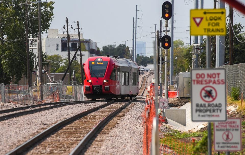 A CapMetro Red Line train makes its way to the Kramer station in August. Some transit-oriented developments have already been built along the Red Line.