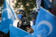 Uyghurs women take part in a protest during the visit of Chinese Foreign Minister Wang Yi in Berlin, Germany, Tuesday, Sept. 1, 2020. German Foreign Minister Heiko Maas meets his Chinese counterpart at the foreign ministry guest house Villa Borsig for bilateral talks. (AP Photo/Markus Schreiber)