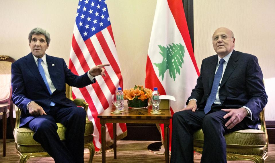 US Secretary of State John Kerry, left, meets with Lebanese Prime Minister Najib Mikati, right, before their meeting at Syria Donors’ Conference at the Bayan Palace in Kuwait, Wednesday, Jan. 15, 2014. (AP Photo/Pablo Martinez Monsivais, Pool)