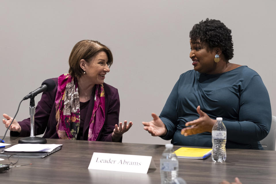 Sen. Amy Klobuchar, left, D-Minn., talks with former Georgia state Rep. Stacey Abrams during a meeting with residents about voting, in Smyrna, Ga., Sunday, July 18, 2021. (AP Photo/Ben Gray)