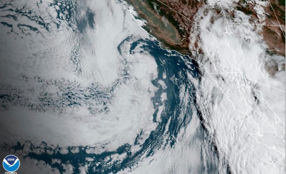 This Saturday, Aug. 19, 2023 11:38 a.m. EDT satellite image provided by the National Oceanic and Atmospheric Administration shows Hurricane Hilary, right, off Mexico’s Pacific coast. Hurricane Hilary headed for Mexico's Baja California on Saturday as the U.S. National Hurricane Center predicted “catastrophic and life-threatening flooding” for the peninsula and for the southwestern United States, where it was forecast to cross the border as a tropical storm on Sunday. (NOAA via AP)