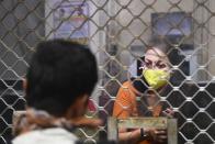 An employee wearing a facemask sits at a counter during a one-day Janata (civil) curfew imposed as a preventive measure against the COVID-19 coronavirus, at a railway station in Kolkata on March 22, 2020. - Nearly one billion people around the world were confined to their homes, as the coronavirus death toll crossed 13,000 and factories were shut in worst-hit Italy after another single-day fatalities record. (Photo by Dibyangshu SARKAR / AFP) (Photo by DIBYANGSHU SARKAR/AFP via Getty Images)