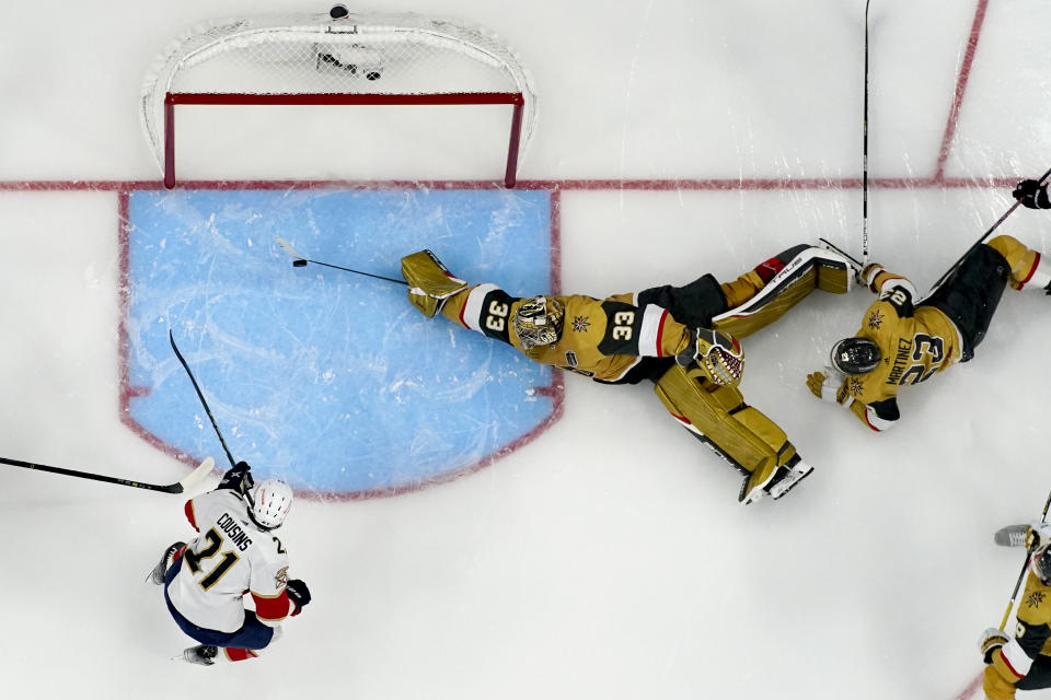 Vegas Golden Knights goaltender Adin Hill (33) blocks a shot on goal by Florida Panthers center Nick Cousins (21) during the second period of Game 1 of the NHL hockey Stanley Cup Finals, Saturday, June 3, 2023, in Las Vegas. (AP Photo/John Locher)