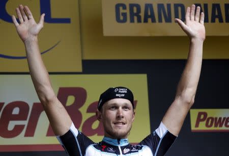 File photo: Omega Pharma-Quick Step team rider Matteo Trentin of Italy celebrates on the podium after winning the 234.5 km seventh stage of the Tour de France cycling race from Epernay to Nancy July 11, 2014. REUTERS/Jean-Paul Pelissier