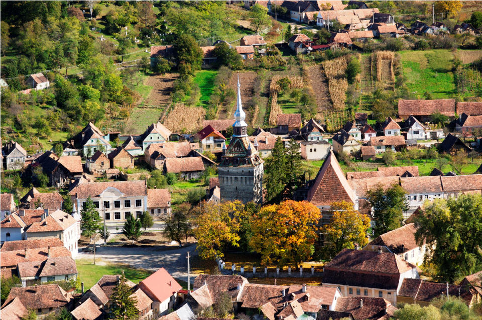 This undated image from Romania Tourism shows rooftops, farms and the church in Saschiz, a town in the Transylvania region of Romania. The area is drawing tourists, including Prince Charles, with quiet scenes of nature and rural life, including rhubarb and elderberry farms. (AP Photo/Romania Tourism)