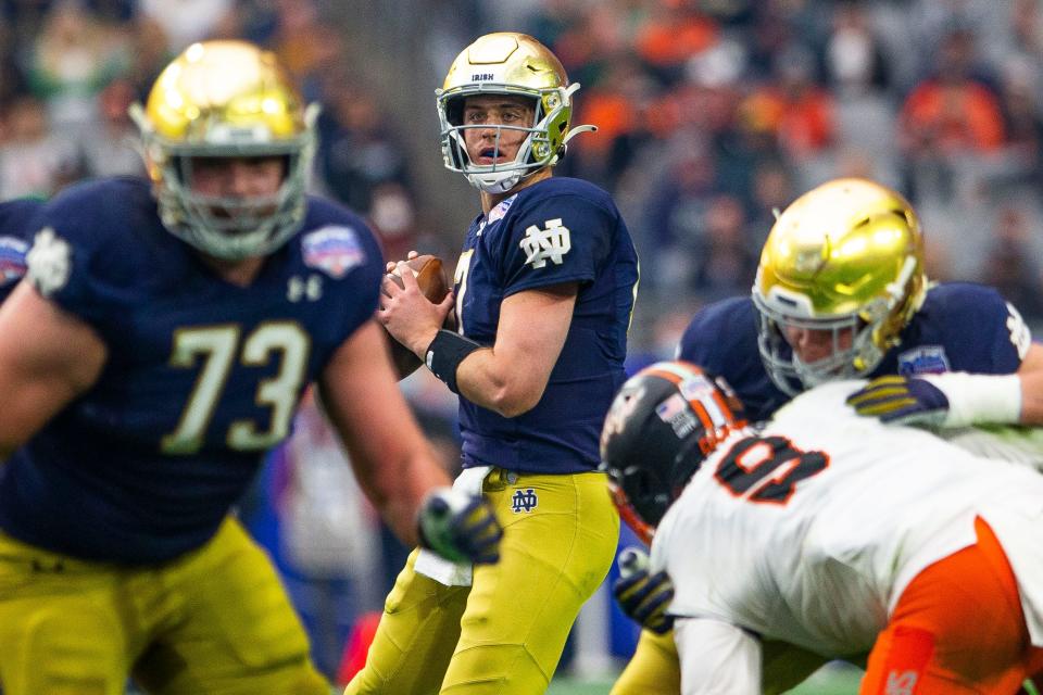 Notre Dame’s Jack Coan (17) looks to throw during the 2022 Playstation Fiesta Bowl Saturday, Jan. 1, 2022 at State Farm Stadium in Glendale, Arizona. 