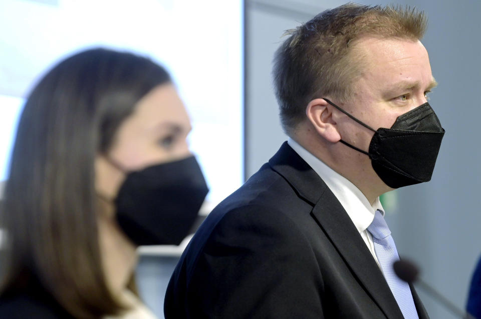 Finland's Prime Minister Sanna Marin, left and Minister of Defense Antti Kaikkonen take part in a press conference, in Helsinki, Finland, Friday, Dec. 10, 2021. (Vesa Moilanen/ Lehtikuva via AP)