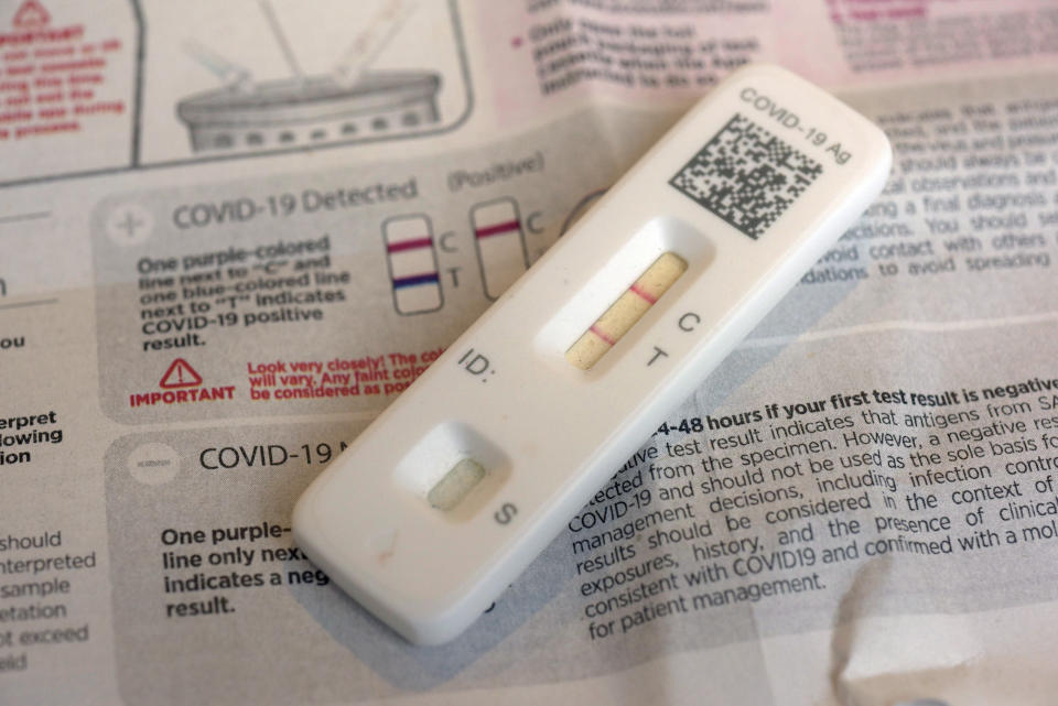 A COVID-19 antigen home test gives a positive result.