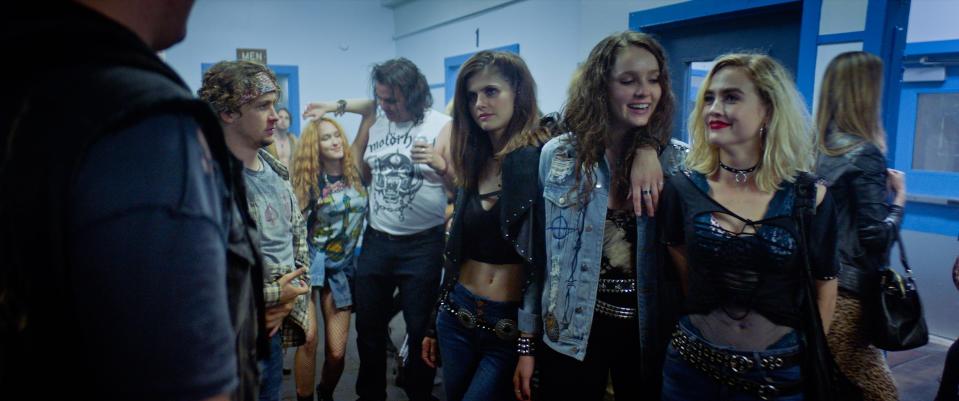 Alexandra Daddario (center), Amy Forsyth and Maddie Hasson star as 1980s-era youngsters whose night out at a rock show turns bloody in the horror comedy "We Summon the Darkness."