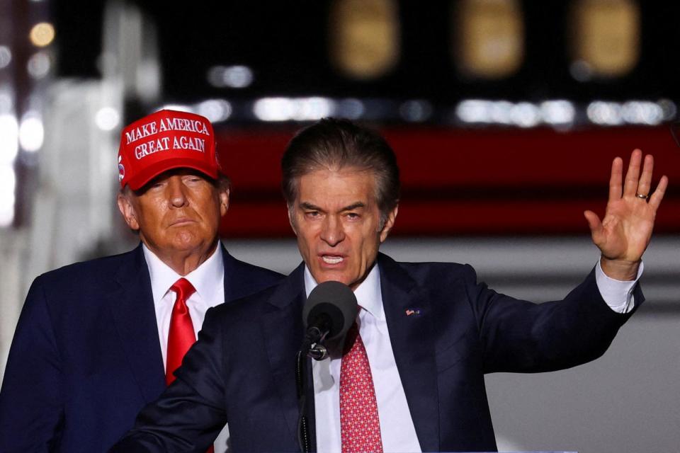 PHOTO: Donald Trump looks on as Dr. Mehmet Oz speaks at a pre-election rally to support Republican candidates in Latrobe, Pennsylvania, Nov. 5, 2022. (Mike Segar/Reuters)