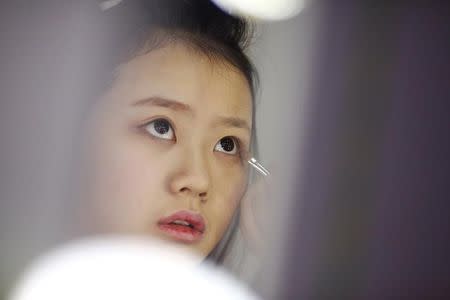 A girl attends make-up training session at live streaming talent agency Three Minute TV in Beijing, China, February 15, 2017. Picture taken February 15, 2017. REUTERS/Thomas Peter