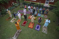Kashmiri Muslims offer Eid prayers in the premises of a residential building in Srinagar, Indian controlled Kashmir, Sunday, May 24, 2020. The holiday of Eid al-Fitr, the end of the fasting month of Ramadan, a usually joyous three-day celebration has been significantly toned down as coronavirus cases soar. (AP Photo/Mukhtar Khan)