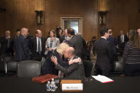 Eugene Scalia hugs his wife Patricia during a break in his nomination hearing for Labor Secretary before the Senate Committee on Health, Education Labor and Pensions on Capitol Hill, in Washington, Thursday, Sept. 19, 2019. (AP Photo/Cliff Owen)