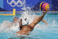 United States' Johnny Hooper (2) scores against Japan during a preliminary round men's water polo match at the 2020 Summer Olympics, Sunday, July 25, 2021, in Tokyo, Japan. (AP Photo/Mark Humphrey)