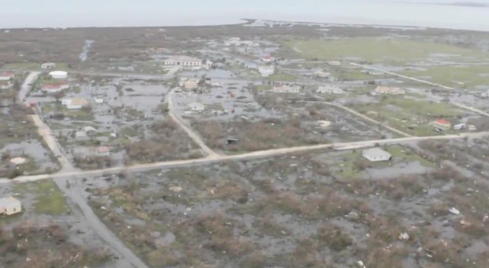 a blurry rainy TV live shot shows Barbuda flattened from Hurricane Irma