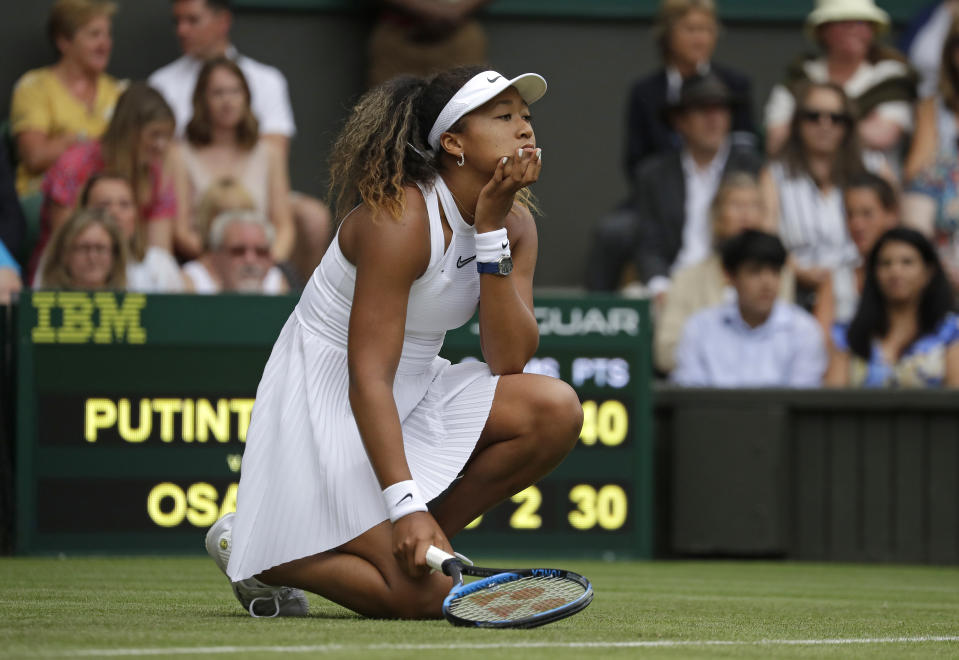 Japan's Naomi Osaka reacts as she plays Kazakstan's Yulia Putintseva in a Women's singles match during day one of the Wimbledon Tennis Championships in London, Monday, July 1, 2019. (AP Photo/Kirsty Wigglesworth)