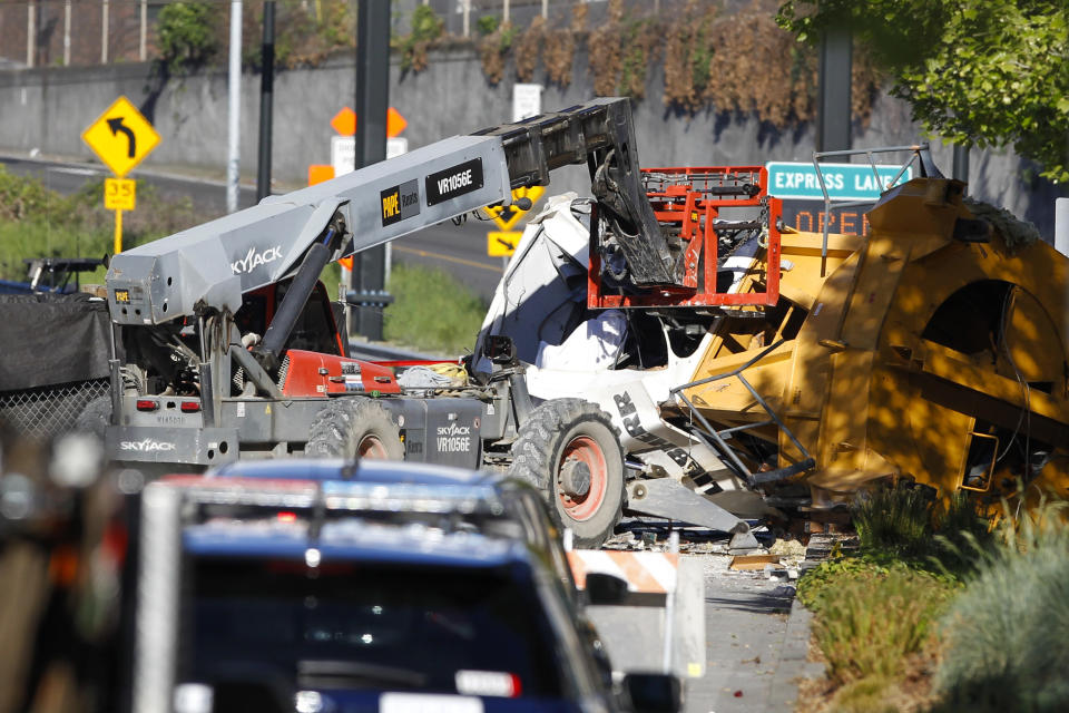 Emergency crews work at the scene of a construction crane collapse where several people were killed and several others injured Saturday, April 27, 2019, in downtown Seattle. The crane collapsed near the intersection of Mercer Street and Fairview Avenue pinning cars underneath near Interstate 5 on Saturday afternoon. (AP Photo/Joe Nicholson)