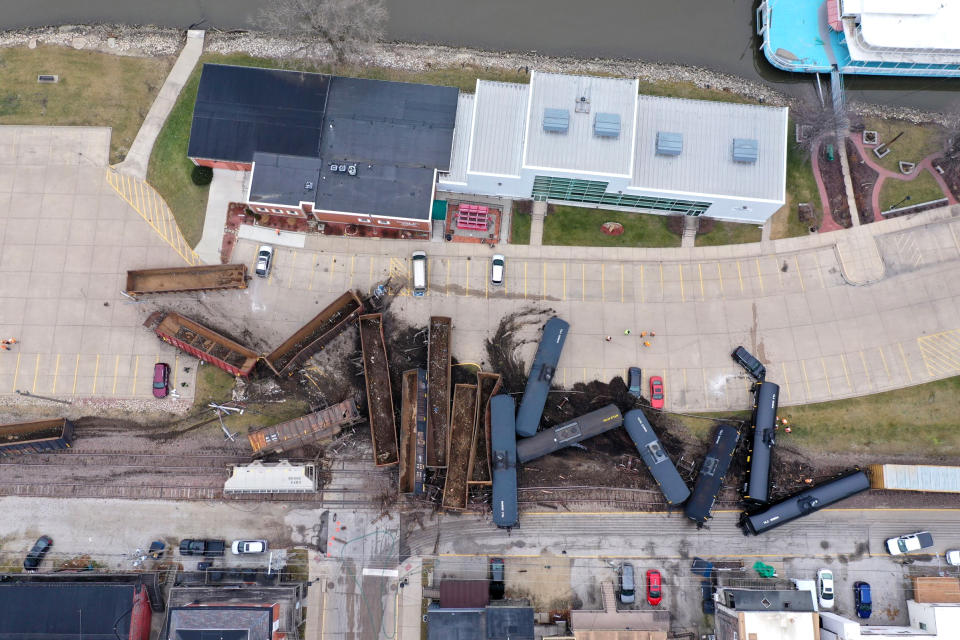 This aerial photo provided by the Scott County, Iowa, Emergency Management Agency shows a train derailment that sent at least a dozen rail cars and tankers off their tracks, the Friday, Jan. 3, 2020 , in downtown LeClaire, Iowa. The derailment, along U.S. Highway 67, just a couple of hundred feet from the banks of the Mississippi River, forced police to send a hazardous materials team to the site. (Scott County Emergency Management Agency via AP)