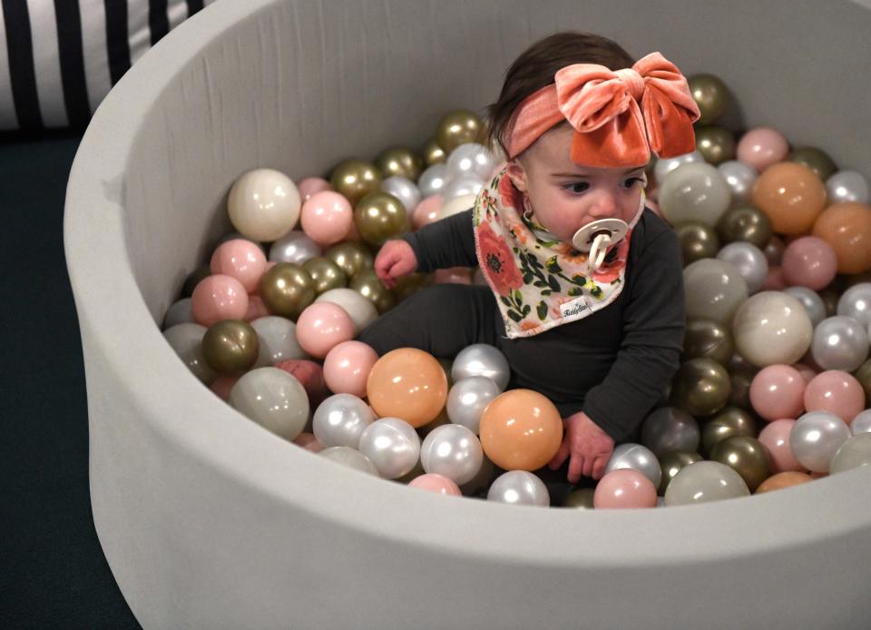 Eight-month-old Maddie Lou Gist plays in a ball pit at The Mom Lounge, Saturday, Jan. 14, 2023.  The "lounge" offers an indoor play area for kids zero to five years old, classes and a space for parents to meet.