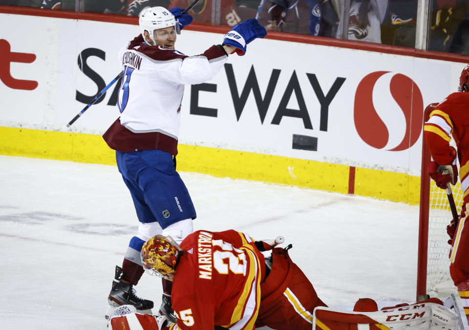 Colorado Avalanche right wing Valeri Nichushkin (13) celebrates his goal as Calgary Flames goalie Jacob Markstrom picks himself up during the third period of an NHL hockey game Tuesday, March 29, 2022 in Calgary, Alberta. (Jeff McIntosh/The Canadian Press via AP)