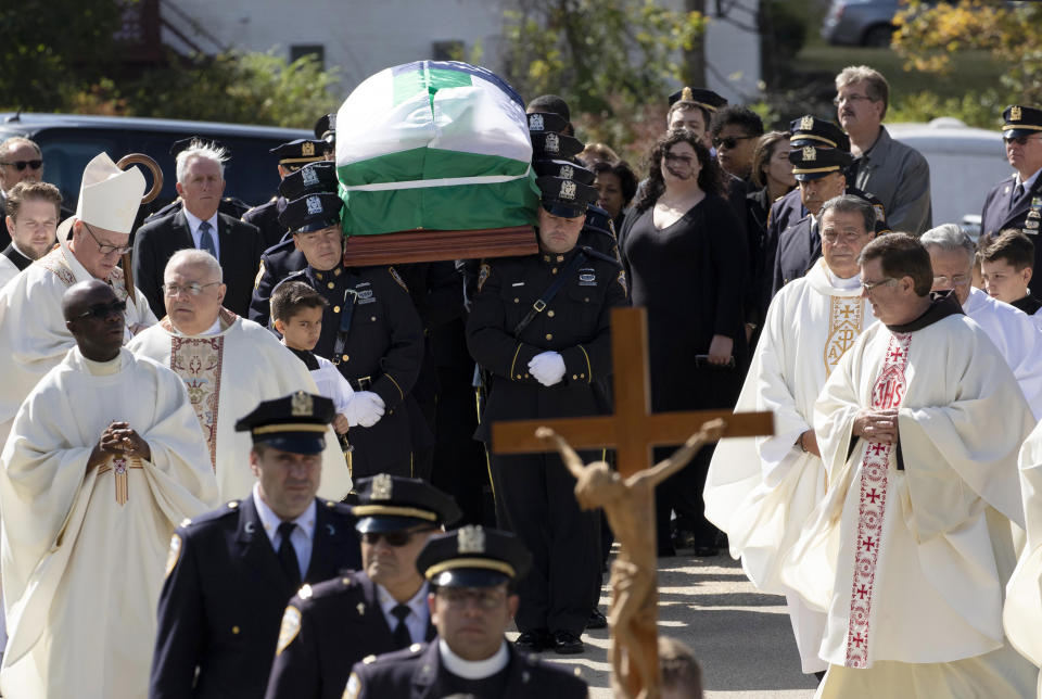 The casket bearing police officers Brian Mulkeen is carried from Church of the Sacred Heart, Friday, Oct. 4, 2019 in Monroe, N.Y. Authorities say Mulkeen was fatally hit Sunday by two police bullets while struggling with an armed man in the Bronx. He is the second New York City officer killed by friendly fire this year. (AP Photo/Mark Lennihan)