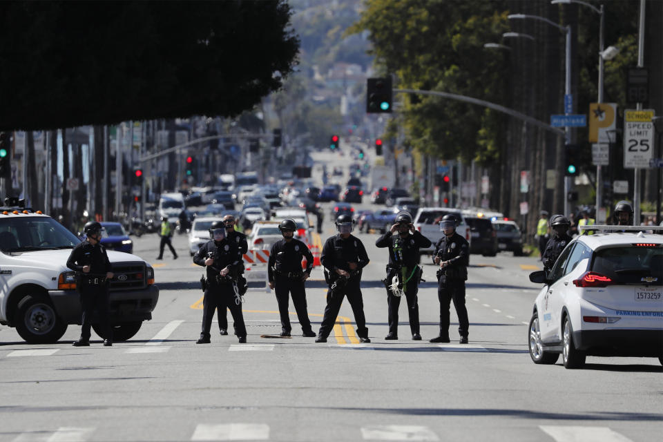 Law enforcement officers hold a line preventing demonstrators in support of Palestinians calling for a ceasefire in Gaza to access the area where the 96th Academy Awards Oscars ceremony is held, Sunday, March 10, 2024, in the Hollywood section of Los Angeles. (AP Photo/Etienne Laurent)