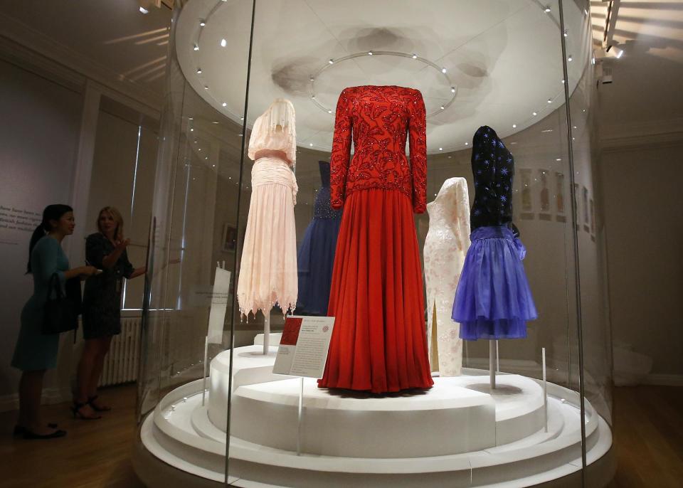 In this photo taken Monday, July 1, 2013, dresses of Princess Diana are displayed at the Fashion Rules exhibition at Kensington Palace in London, Monday, July 1, 2013. Opening on 4 July, a new glamorous exhibit at Kensington Palace showcases how the styles of three royal ladies; Queen Elizabeth II, her sometimes risque sister Margaret, and the glamorous Princess Diana, each reflected and influenced the trends of their fashion heyday. (AP Photo/Frank Augstein)