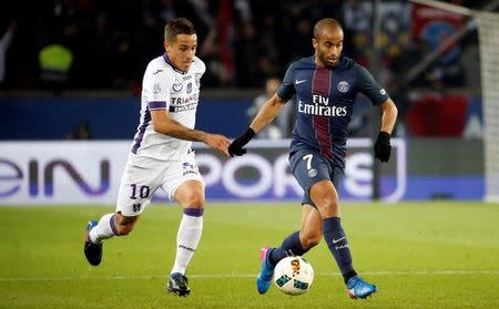 French Football Soccer - Paris Saint Germain FC v Toulouse - French Ligue 1 - Parc des Princes stadium, 19/2/2017. Lucas of Paris Saint Germain FC in action with Oscar Trejo of Toulouse. REUTERS/Charles Platiau