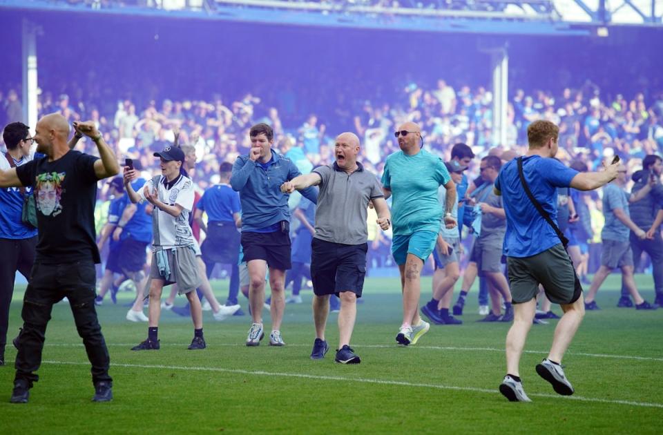Jubilant Everton invade the pitch after the final whistle (PA)