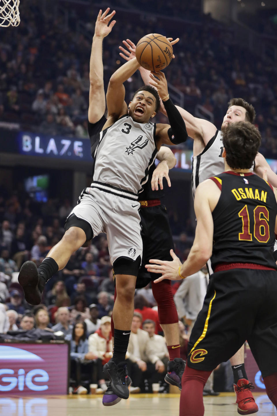 San Antonio Spurs' Keldon Johnson (3) grabs a rebound against the Cleveland Cavaliers in the first half of an NBA basketball game, Sunday, March 8, 2020, in Cleveland. (AP Photo/Tony Dejak)