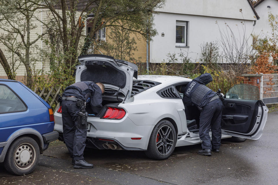 CORRECTS CAPTION INFORMATION - Police officers search a car during a raid in Garbsen, Germany, Thursday, Nov. 23, 2023. German police arrested two men Thursday in connection with organized smuggling of migrants during raids in Berlin and the northern state of Lower Saxony. About 260 officers were involved in the raids in which 14 properties were searched, eight in Lower Saxony and six in Berlin. (Ole Spata/dpa via AP)