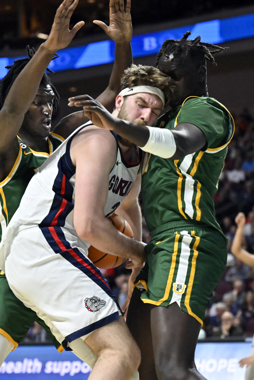 Gonzaga forward Drew Timme, center, collides with San Francisco forward Josh Kunen, right, as forward Ndewedo Newbury defends during the second half of an NCAA college basketball game in the semifinals of the West Coast Conference men's tournament Monday, March 6, 2023, in Las Vegas. (AP Photo/David Becker)