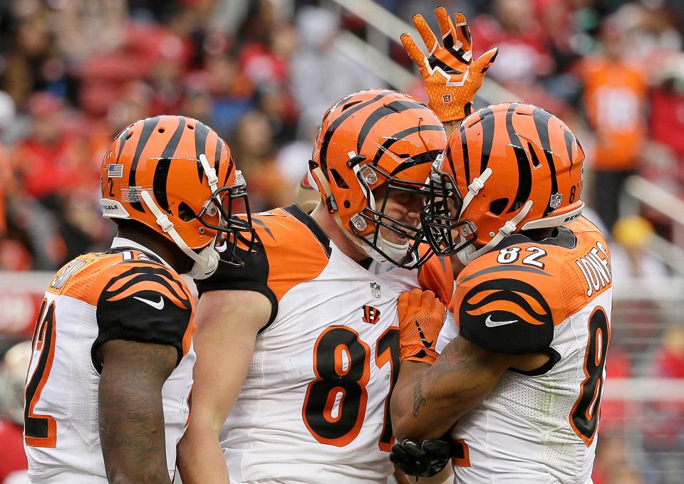 Cincinnati Bengals tight end Tyler Kroft, center, celebrates with wide receiver Mohamed Sanu, left, and wide receiver Marvin Jones (82) after scoring on a touchdown reception against the San Francisco 49ers during the first half of an NFL football game in Santa Clara, Calif., Sunday, Dec. 20, 2015. (AP Photo/Eric Risberg)