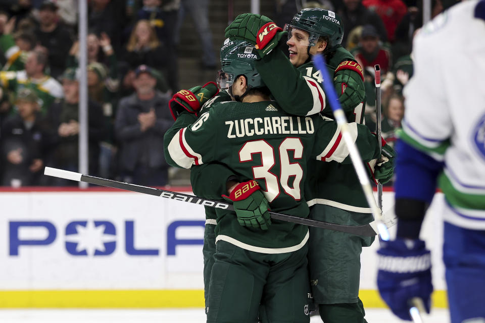 Minnesota Wild center Joel Eriksson Ek is congratulated for his hat-trick against the Vancouver Canucks during the third period of an NHL hockey game, Monday, Feb. 19, 2024, in St. Paul, Minn. (AP Photo/Matt Krohn)