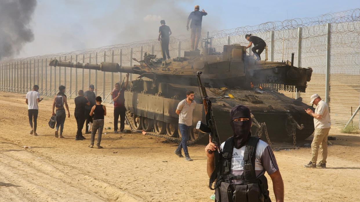  Hamas fighters destroy an Israeli tank in Gaza City on 7 October. 