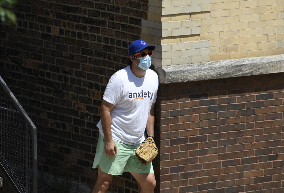 Shawn Bosman waits to catch a ball outside of Wrigley Field during batting practice before a baseball game between the Chicago Cubs and the Milwaukee Brewers, Sunday, July, 26, 2020, in Chicago. (AP Photo/David Banks)