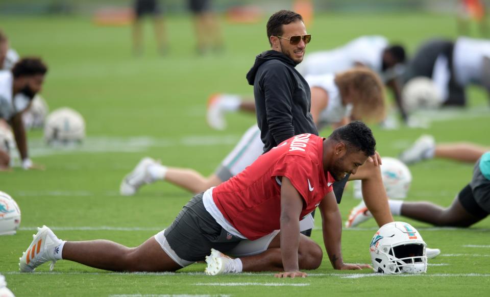 Miami Dolphins head coach Mike McDaniel talks with quarterback Tua Tagovailoa during training camp at Baptist Health Training Complex, Wednesday, July 27, 2022 in Miami Gardens.