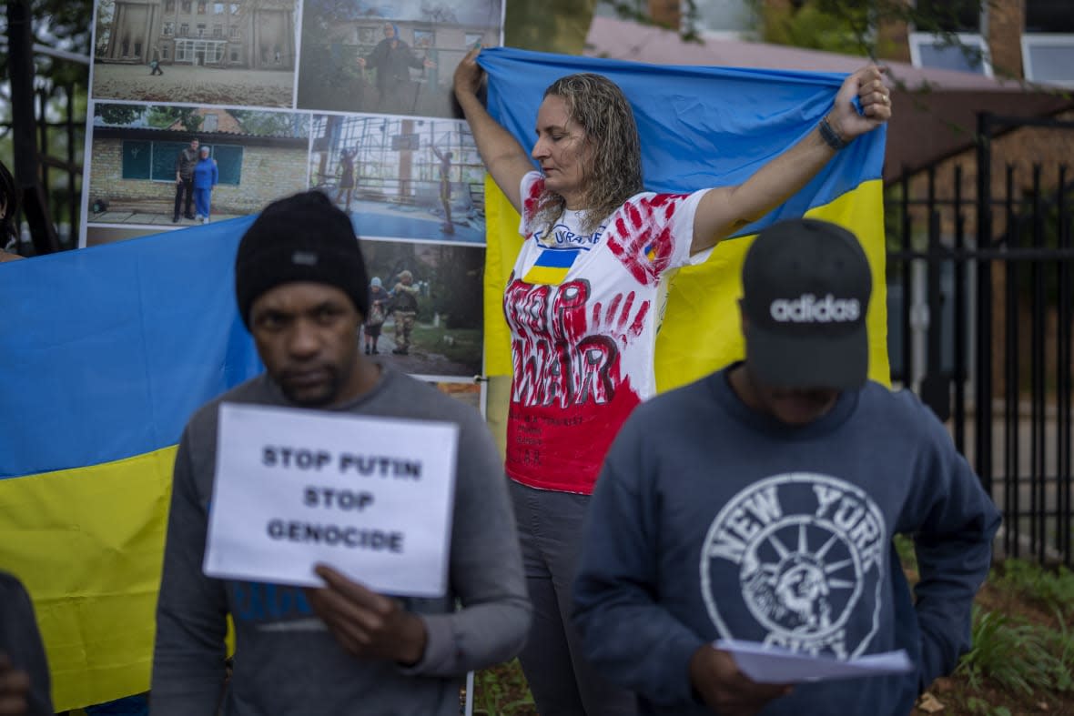 South African nationals join Ukrainians as they demonstrate outside the Russian Embassy in Pretoria, South Africa, Wednesday, Feb. 22, 2023. A group of around 40 gathered to protest against the Russian invasion of Ukraine and the joint military naval exercises being held by the South Africa Defence Force and their Russian and Chinese counterparts. (AP Photo/Jerome Delay)