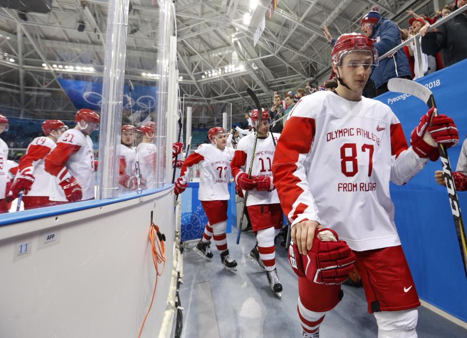 Members of the Olympic Athletes from Russia hockey team leave the ice dejected after losing their opener against Slovakia at the Winter Olympics. (Reuters)