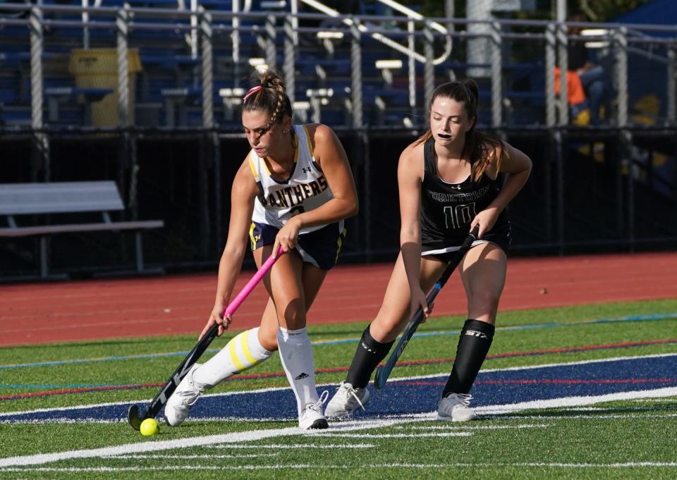 Panas' Hayley Madden (5) works the ball against Yorktown's Clare Ryen (10) during field hockey action at Walter Panas High School in Cortlandt on Thursday, September 21, 2023.