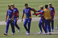 Karachi Kings' Arshad Iqbal, center, celebrates with teammates after taking the wicket of Multan Sultans' James Vince during a Pakistan Super League T20 cricket match between Karachi Kings and Multan Sultans at the National Stadium, in Karachi, Pakistan, Saturday, Feb. 27, 2021. (AP Photo/Fareed Khan)