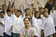 Two-time Grand Slam champion Li Na poses with students at the tennis clinic she led at the Sutton East Tennis Club Thursday, July 18, 2019, in New York. Li Na will be inducted into the Tennis Hall of Fame on Saturday, July 20. (AP Photo/Kevin Hagen)