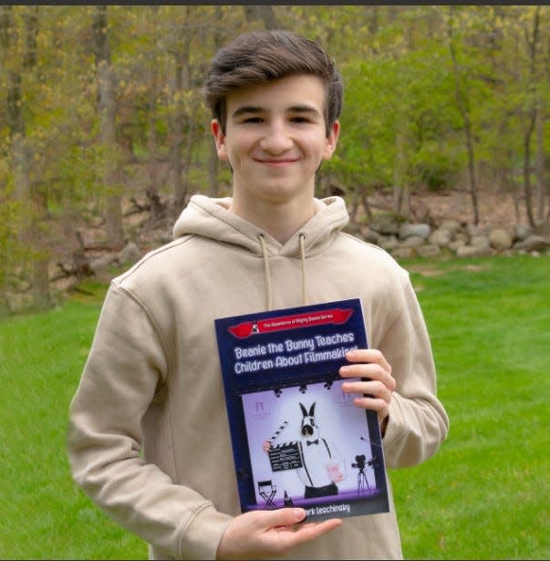 Mark Leschinsky of Mahwah, founder of the Student World Impact Film Festival, displays children's book he wrote on filmmaking.