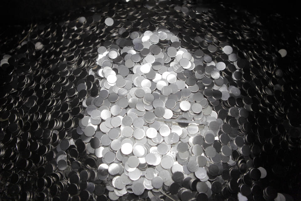 Unmarked 5 cent coins sit in a pile after being cut from a coil at the U.S. Mint on Wednesday, June 27, 2012, in Philadelphia. The new $3.9 million exhibit opens a new tour to visitors on July 3 and it's the first upgrade in more than 40 years.(AP Photo/Brynn Anderson)