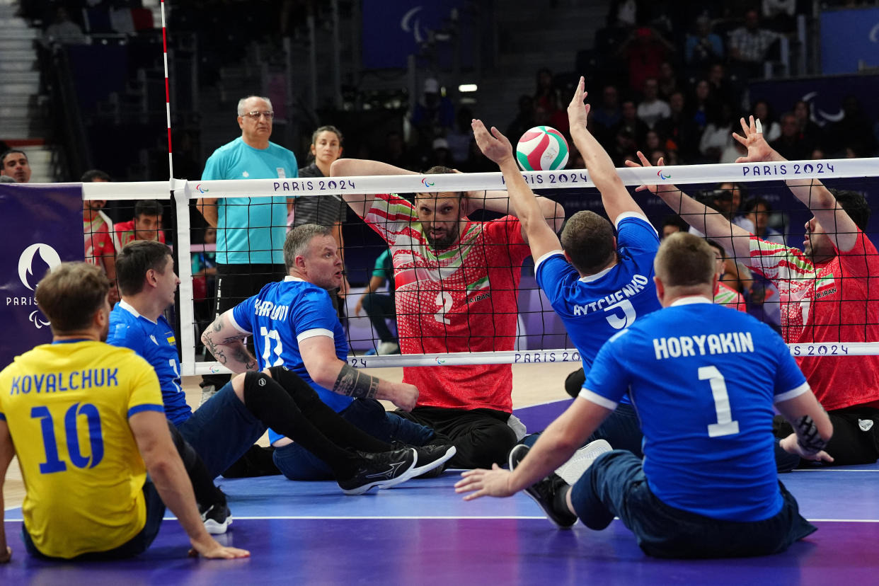 Iran's #2 Morteza Mehrzadselakjani (C) competes during the sitting volleyball men's preliminary round pool B match between Iran and Ukraine. / Credit: DIMITAR DILKOFF/AFP via Getty Images