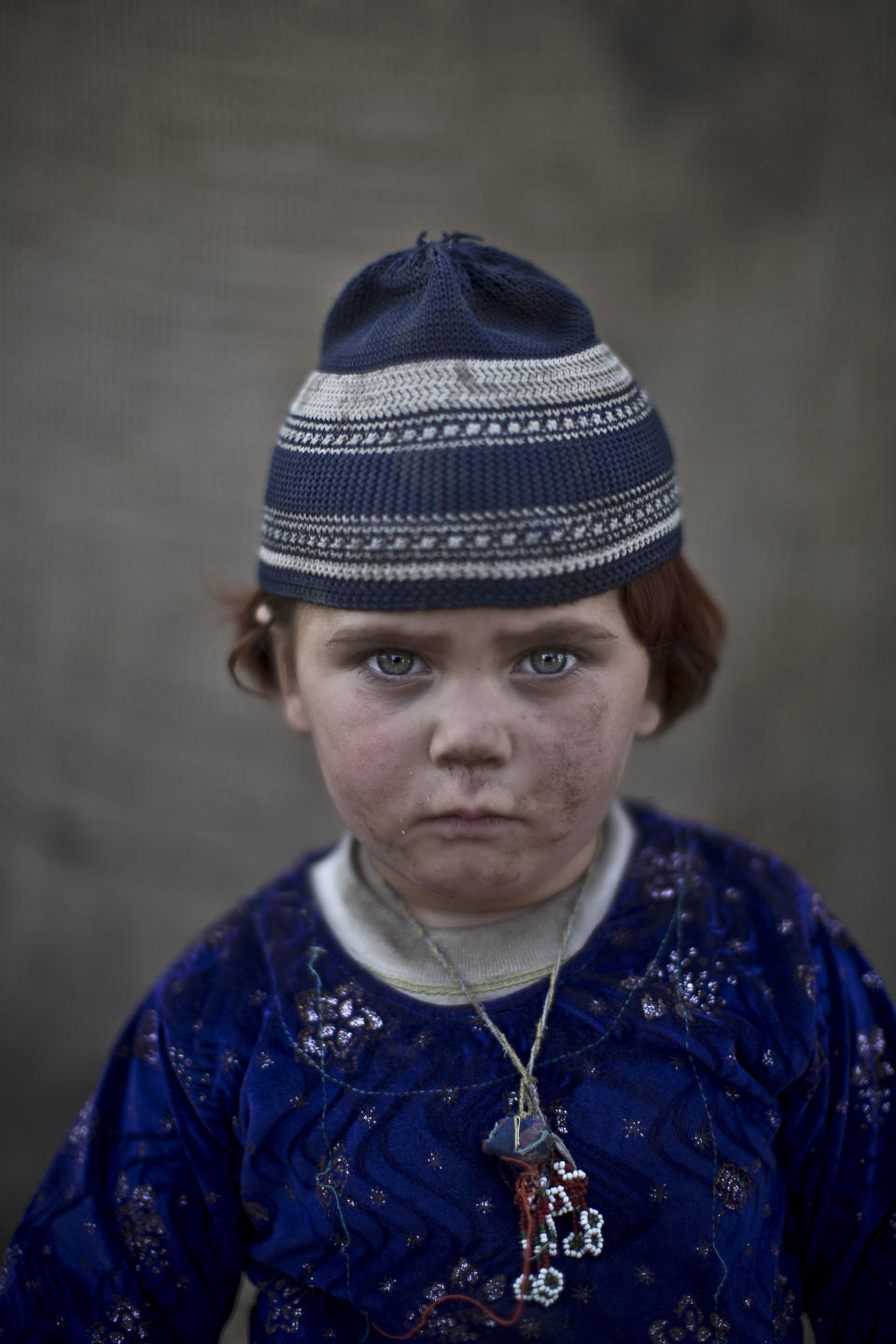 In this Saturday, Jan. 25, 2014, photo, Afghan refugee girl, Basmina, 3, poses for a picture, while playing with other children in a slum on the outskirts of Islamabad, Pakistan. For more than three decades, Pakistan has been home to one of the world’s largest refugee communities: hundreds of thousands of Afghans who have fled the repeated wars and fighting their country has undergone. Since the 2002 U.S.-led invasion of Afghanistan, some 3.8 million Afghans have returned to their home country, according to the U.N.’s refugee agency. (AP Photo/Muhammed Muheisen)